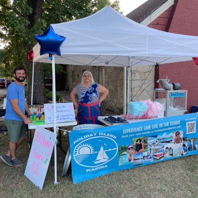 a group of people standing in the grass