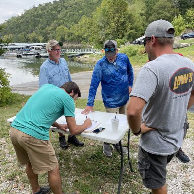 a group of people standing in the grass