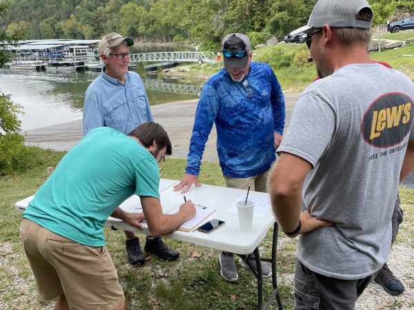 a group of people standing in the grass