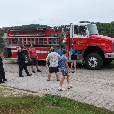 a group of people standing around a fire truck