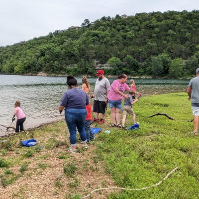a group of people that are standing in the grass